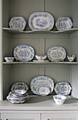 Decorative china plates on shelves