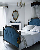 Old fashioned bedroom with double bed and canopy