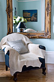 Large mirror above armchair in luxury interior