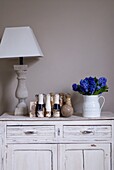 Decorative bowling pins and ball on old rustic dresser