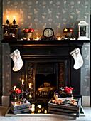 Christmas stockings and it candles on London fireplace