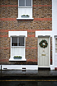 Brick terraced house with door wreath in Richmond-on-Thames London