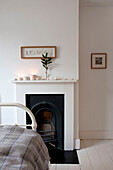 Original fireplace in white bedroom of Richmond home