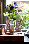 Kitchen worktop with chopping board kitchenware and flower display
