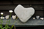 Heart shaped pebbles and stones displayed in a garden