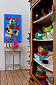 Kitchen storage and colourful artwork of cow in modern Odense family home Denmark