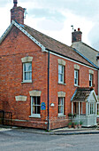 Traditional brick corner house end of terrace UK
