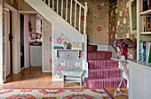 Carpeted staircase with contemporary floral wallpaper in staircase hallway of London home England UK
