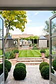 Garden exterior of London townhouse from conservatory extension England UK