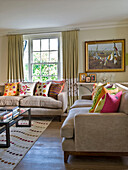 Assorted cushions on sofas in drawing room of West London townhouse England UK