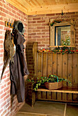 Pheasants hang in cloakroom of rural Suffolk home with cut leaves for Christmas decoration England UK