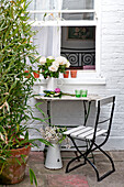 Flower arranging on backyard table of London home, UK