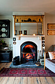 Gilt mirror above coal fire in Walberton home, West Sussex, England, UK