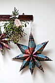 Star shaped Christmas decoration and mistletoe in Walberton home, West Sussex, England, UK
