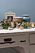 Homeware and tealights on distressed dressing table in Forest Row family home, Sussex, England, UK