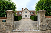 Stone gateposts and hedging at access driveway to Buckinghamshire home, England, UK