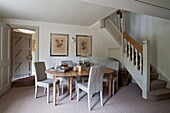 Oval shaped wooden dining table in hallway of Buckinghamshire home, England, UK