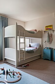 Bunk bed in child'd room with car track on floor, Buckinghamshire home, England, UK