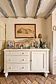 Painted sideboard with ornaments and artwork of lion in Suffolk farmhouse, England, UK