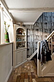 Trompe d'oeil and corner cabinet in Suffolk farmhouse hallway, England, UK