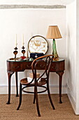 Antique dressing table and chair with vintage lamp in Suffolk farmhouse, England, UK