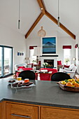 Chocolate brownies and fruit on grey worktop of open plan living room kitchen in contemporary home, Cornwall, England, UK