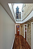 Double height, exposed brick hallway in London home, England, UK