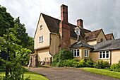 Brick chimneys and garden exterior of Essex/Suffolk home, England, UK