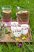Tray of cups with pink lemonade and posies in Brecon, Powys, Wales, UK
