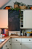 Chalkboard in white fitted kitchen of Shropshire cottage, England, UK