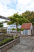 Garden shed and greenhouse with raised beds in Blagdon, Somerset, England, UK