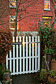 White gate at brick exterior of rural country house Tregaron Wales UK