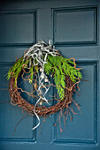 Christmas wreath with silver baubles on turquoise front door of Crantock home Cornwall England UK