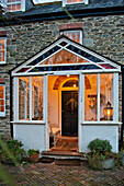 View into lit porch of Crantock home Cornwall England UK
