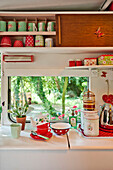 Kitchenware and cupboard at window of caravan