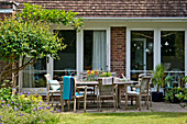 Wooden patio furniture on terrace of East Grinstead house Sussex England UK