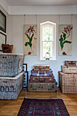 Tulip artwork with vintage suitcases and wicker baskets in Stamford home Lincolnshire England UK