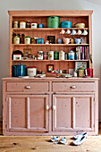 Kitchenware on painted dresser in Cambridge cottage England UK