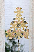 Gold snowflake doilies with lace curtains in window of London home England UK