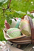 Hand made Easter eggs in basket on garden table Sussex England UK