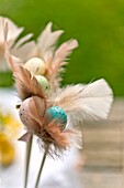 Easter eggs and feather decorations on Sussex garden table England UK