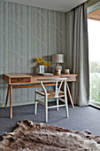 Wooden desk and chair in grey carpeted bedroom of Lechlade home Gloucestershire England UK
