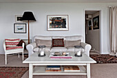 Framed artwork above sofa with coffee table in beach house Cornwall England UK