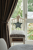 Light blue star on chair at door in Penzance farmhouse Cornwall England UK
