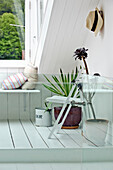 Window seating with houseplants in attic conversion of family townhouse Cornwall England UK