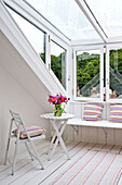 Table and chair in dormer window of attic conversion in family townhouse Cornwall England UK