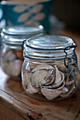 Glass storage jar with seashells in holiday cottage Cornwall UK