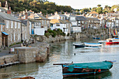Rowing boats moored at seafront in Mousehole Cornwall UK