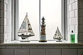 Model boats and lighthouse on windowsill in St Ives home Cornwall England