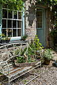 Gardening trug on metal framed bench in garden exterior of Helston home Cornwall UK